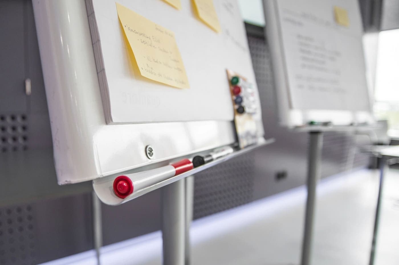 Notes pinned to a whiteboard in a meeting room.